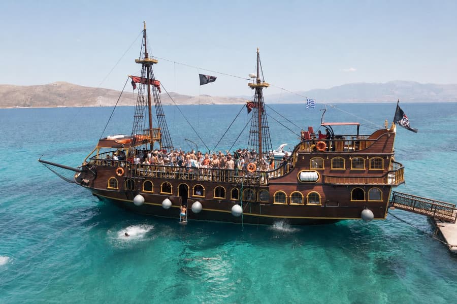 Aerial view of the Barco De Pirata anchored over clear turquoise Aegean water off Kos.